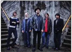  ?? (AP) ?? Drive-By Truckers (from left) Brad Morgan, Patterson Hood, Matt Patton, Mike Cooley and Jay Gonzalez pose in front of the Walnut Street Bridge in Chattanoog­a, Tenn. The band’s new album is titled The Unraveling.