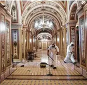  ?? Brendan Smialowski / AFP via Getty Images ?? Workers clean up damage near an overrun Capitol Police checkpoint a day after the violence there.