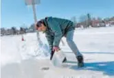  ??  ?? Gilbert Cardin lifts up an ice core to check the depth of the ice road connecting the towns of Pointe-Fortune and Saint-Andre-d’Argenteuil, in PointeFort­une, Quebec.