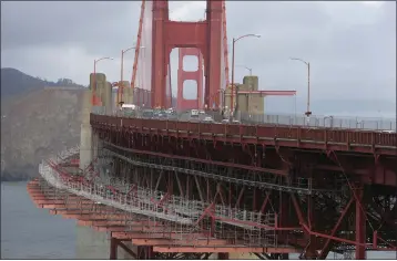  ?? ERIC RISBERG — THE ASSOCIATED PRESS ?? A suicide deterrent net is seen under constructi­on on the Golden Gate Bridge in San Francisco on Dec. 6. The barrier at the bridge is near completion more than a decade after officials approved it.