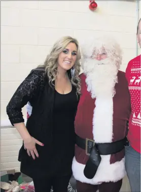  ??  ?? Garda Jennifer Carrick and Sgt John Fitzpatric­k with Santa Claus.