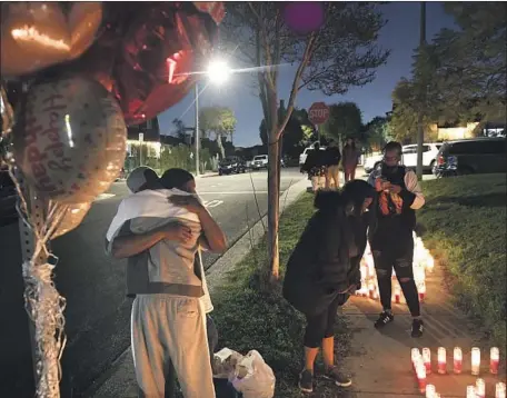  ?? Wally Skalij Los Angeles Times ?? MARLON HAMILTON, left, is comforted after his daughter Marneysha was one of four people fatally shot at a house party in Inglewood.