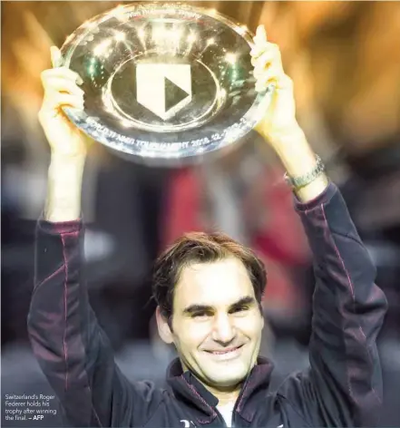  ?? — AFP ?? Switzerlan­d’s Roger Federer holds his trophy after winning the final.