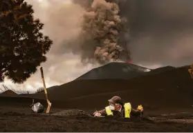  ?? Taner Orribo / Associated Press ?? A scientist from the Spanish National Research Council collects volcanic ash samples Nov. 18 on the island of La Palma. The eruption began on Sept. 19.