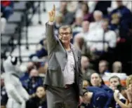  ?? JESSICA HILL — THE ASSOCIATED PRESS FILE ?? Connecticu­t head coach Geno Auriemma gestures to his team during the first half of an NCAA college basketball game against South Florida in the American Athletic Conference tournament finals in Uncasville, Conn. UConn finished No. 1 in The Associated...