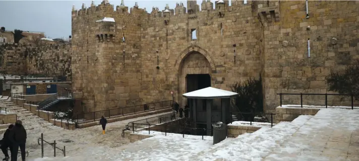  ??  ?? Snow that fell overnight melts on the steps leading to the Damascus Gate of the Old City of Jerusalem yesterday. Photo: AP