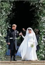  ?? [POOL PHOTO BY JANE BARLOW/AP] ?? Meghan Markle wears a sleek white Givenchy haute couture gown Saturday as she and Britain’s Prince Harry walk down the steps of St. George’s Chapel at Windsor Castle in Windsor, near London, England, after their wedding.