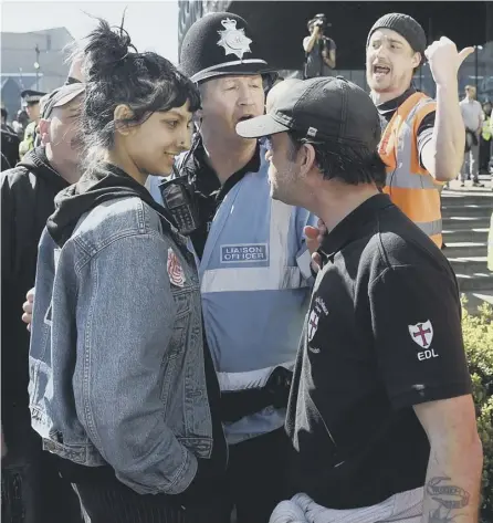  ??  ?? 0 The photograph of Saffiyah Khan facing down Ian Crossland at an EDL demonstrat­ion in Birmingham has gone viral