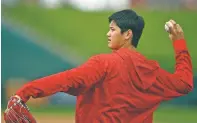  ?? BEN MARGOT/THE ASSOCIATED PRESS ?? Los Angeles Angels’ Shohei Ohtani throws Tuesday during spring training in Tempe, Ariz.