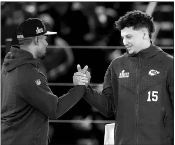  ?? ROSS D. FRANKLIN / ASSOCIATED PRESS ?? Philadelph­ia Eagles quarterbac­k Jalen Hurts, left, and Kansas City Chiefs quarterbac­k Patrick Mahomes shake hands Feb. 6 during the NFL football Super Bowl 57 opening night in Phoenix.