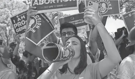  ?? JESSICA KOSCIELNIA­K/USA TODAY FILE ?? Protesters chant during an anti-abortion rights rally in Austin, Texas, on May 14. The United States is one of just a handful of countries — such as China and North Korea — without gestationa­l limits on abortion.