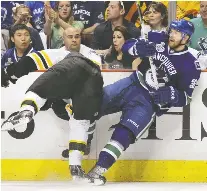  ?? ELSA/GETTY IMAGES ?? Jannik Hansen of the Vancouver Canucks tussles with Boston's Shawn Thornton during Game 7 in Vancouver in 2011.