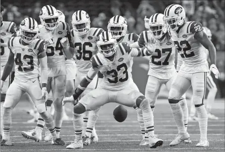  ?? RICK OSENTOSKI/AP PHOTO ?? Jets defensive back Jamal Adams celebrates his intercepti­on with teammates last Monday during the second half against the Lions in Detroit.