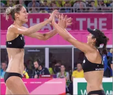  ?? CP PHOTO ?? Sarah Pavan, left, and Melissa Humana-Paredes celebrate after winning the gold medal in beach volleyball.