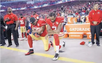  ?? JOSE SANCHEZ/ASSOCIATED PRESS FILE ?? In this Sept. 12, 2016, photo, then-49ers quarterbac­k Colin Kaepernick (7) takes a knee during the national anthem before San Francisco’s game against the LA Rams. At left is teammate Eric Reid.