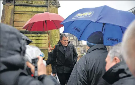  ?? Picture: Jamie Simpson ?? ENGAGING: Architect John McAslan takes to George Square in the rain to talk to people to try to win support for his plans which were dropped by the council leader.
