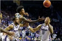  ?? AP photo ?? Baylor forward Jalen Bridges, (top) Kansas State guard Markquis Nowell and Kansas State forward Keyontae Johnson (11) go after a loose ball during the first half Tuesday. Kansas State won 76-65.