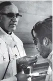  ?? COTERA/ THE ASSOCIATED PRESS/ FILE ?? Archbishop Oscar Romero offers communion to a parishione­r during a mass in 1980.