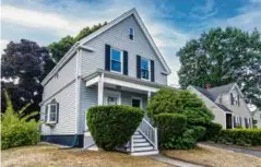  ?? ?? FROM TOP The kitchen features an island with seating and a butcherblo­ck top; the home sits on a 0.13acre corner lot; and the owners took down a wall and absorbed the third bedroom to make the primary bedroom bigger.