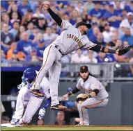  ?? JOHN SLEEZER/TRIBUNE NEWS SERVICE ?? The Royals' Paulo Orlando advances to third on the throw to Giants third baseman Eduardo Nunez on a groundout by Alex Gordon in Kansas City, Mo., on Wednesday.