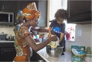  ??  ?? Flatley is helped in the kitchen by her 1-year-old son, Zachery, in making empanadas.