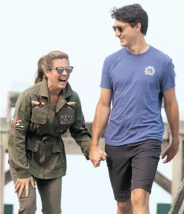  ?? DARRYL DYCK / THE CANADIAN PRESS ?? Prime Minister Justin Trudeau and his wife Sophie Grégoire Trudeau during a visit to Sidney Spit in the Gulf Islands National Park Reserve, B.C., last summer.