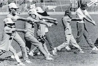  ?? Longmont Times-call File/longmont Museum ?? Players practice their swing without bats at the Spectrum Sports Baseball Camp in June 1988. The camp, based at Longmont’s Centennial Park, was led by Bob Bote.