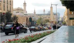  ??  ?? People walk along Beirut’s commercial district in downtown Lebanon.