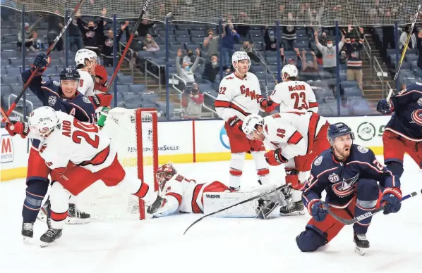  ?? ADAM CAIRNS/COLUMBUS DISPATCH ?? Blue Jackets forward Oliver Bjorkstran­d (28) and his teammates celebrate his game-tying goal with 15.1 seconds in regulation against Carolina on Thursday.