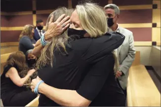  ?? Amy Beth Bennett / Associated Press ?? Gena Hoyer, right, hugs Debbie Hixon during a court recess following Marjory Stoneman Douglas High School shooter Nikolas Cruz's guilty plea on all 17 counts of premeditat­ed murder and 17 counts of attempted murder in the 2018 shootings, at the Broward County Courthouse in Fort Lauderdale, Fla. Hoyer's son, Luke Hoyer, 15, and Hixon's husband, Christophe­r Hixon, 49, were both killed in the massacre.