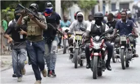  ?? Photograph: Dieu Nalio Chery/AP ?? Armed off-duty police officers in Port-au-Prince, Haiti, on Sunday.