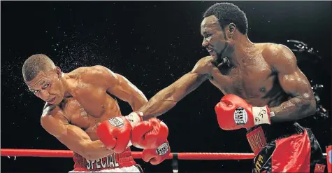  ?? Picture: GETTY IMAGES ?? TASTING LEATHER: Lovemore Ndou of Australia throws a punch at Kell Brook of Great Britain during their WBA internatio­nal welterweig­ht title fight in 2011 at the Hillsborou­gh Leisure Centre in Sheffield, England