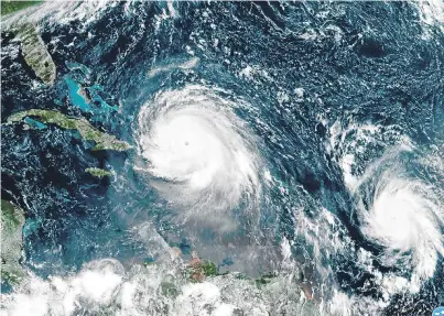  ??  ?? The eye of Hurricane Irma, centre, just north of the island of Hispaniola.
