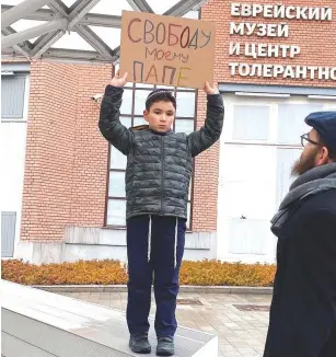  ?? ?? THE SON of Revaz Raphael Shmertz protesting with a sign that says ‘freedom for my father.’ (Shmertz family)