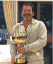  ??  ?? The winner of the 37th Lamlash Open Cup, reported in last week’s Banner, was Serge El Adm with a score of 120 for the two rounds seen here smiling with his trophy.