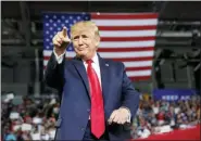  ?? CAROLYN KASTER - THE ASSOCIATED PRESS ?? President Donald Trump gestures to the crowd as he arrives to speak at a campaign rally at Williams Arena in Greenville, N.C., Wednesday.
