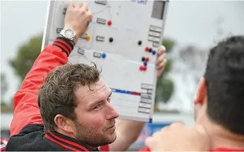  ?? Photograph­s by CRAIG JOHNSON. ?? Warragul senior coach Jed Lamb gives his team one final rev up at three quarter time against Wonthaggi.