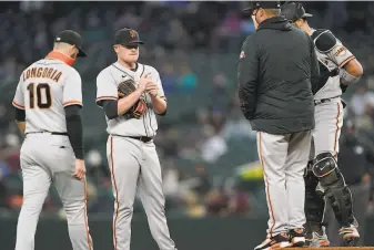  ?? Ted S. Warren / Associated Press ?? Giants starting pitcher Logan Webb talks with pitching coach Andrew Bailey, joined by third baseman Evan Longoria and catcher Curt Casali. Webb allowed three runs in 51⁄3 innings.