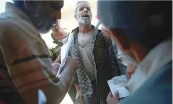  ?? — Reuters ?? A Syrian man is seen in front of a food aid centre in Douma, near Damascus, Syria, on Sunday.