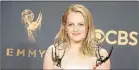  ??  ?? LEADING LADY: Elisabeth Moss with her Emmys for outstandin­g lead actress in a drama series and outstandin­g drama series for ‘The Handmaid's Tale’
