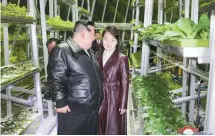  ?? Yonhap ?? North Korean leader Kim Jong-un, left, attends a ceremony alongside his daughter, believed to be named Ju-ae, to mark the completion of the Kangdong Greenhouse Farm in Pyongyang, Friday.