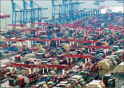  ?? Chinatopix via AP ?? Containers are stored at a port earlier this month in Qingdao, China. U.S. President Donald Trump pushed back a deadline this Friday to escalate tariffs on Chinese imports, citing “substantia­l progress” in weekend talks between the two countries.