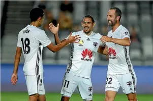  ?? GETTY IMAGES ?? David Williams, centre, is congratula­ted by Sarpreet Singh and Andrew Durante after scoring the Phoenix’s third goal in their 8-2 rout.