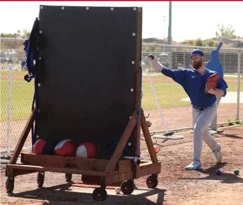  ?? JOHN ANTONOFF/SUN-TIMES PHOTOS ?? In addition to the mobile plyo wall (above), Cubs pitching coordinato­r James Ogden built strike zones out of string held together with PVC pipe (left).