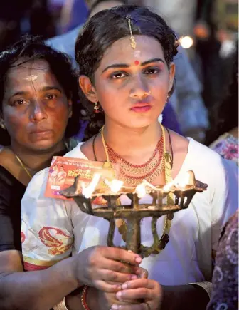  ?? ?? Devotional fervour: The traditiona­l five-wick lamp is an important part of the festival.