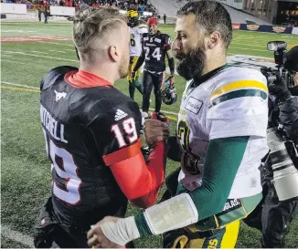  ?? JEFF MCINTOSH/THE CANADIAN PRESS ?? Stampeders quarterbac­k Bo Levi Mitchell shakes hands with Eskimos counterpar­t Mike Reilly at the conclusion of Sunday’s West final at McMahon Stadium. The Stamps won 32-28 to advance to the 105th Grey Cup Sunday in Ottawa.