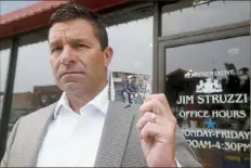  ?? Pittsburgh Post-Gazette ?? Rep. Jim Struzzi holds a photograph of his younger brother, Michael, in front of his Indiana County office on July 29, 2021. Mr. Struzzi lost his brother to a drug overdose a decade ago. “I’m happy the bill passed, and I appreciate that the Judiciary moved it out of committee,” he said. “I look forward to gaining more support for this.”