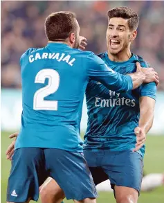  ?? - AFP photo ?? Real Madrid’s Spanish midfielder Marco Asensio (R) celebrates a goal with Real Madrid’s Spanish defender Dani Carvajal during the Spanish Liga football match Real Betis vs Real Madrid at the Benito Villamarin stadium in Sevilla.