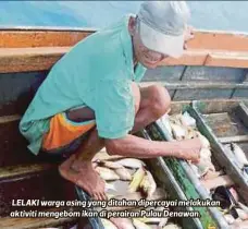  ??  ?? LELAKI warga asing yang ditahan dipercayai melakukan aktiviti mengebom ikan di perairan Pulau Denawan.