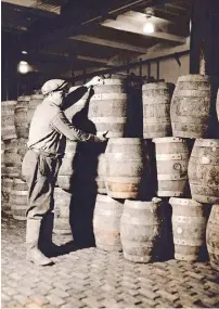  ??  ?? Man stacking barrels in brewery warehouse, no date, blackand-white photograph, courtesy Culver Pictures, Inc.